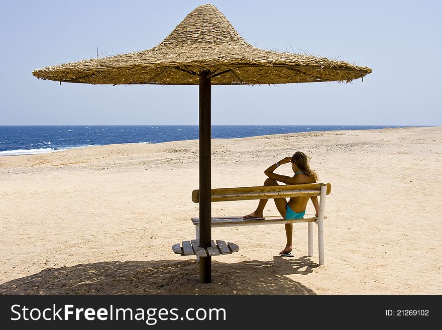 Blond girl sitting on the bench at the Red Sea Marsa Alam in Egypt