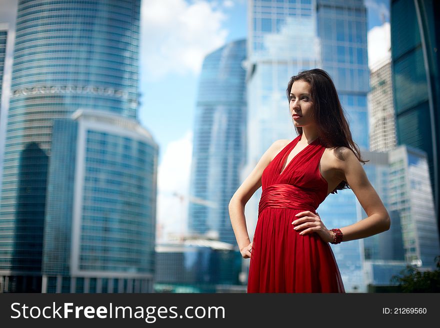 Beautiful girl in the background of glass buildings. Beautiful girl in the background of glass buildings