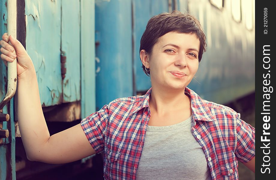 Retro portrait of young woman near train