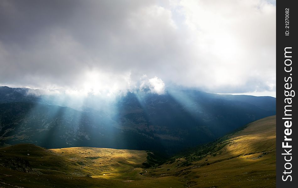 Mountain landscape with sun rays in Parang Mountains in Romania