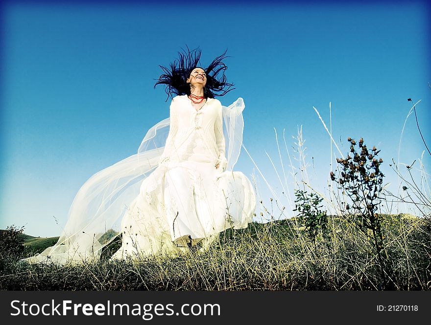 Portrait of romantic woman jumping on field. Portrait of romantic woman jumping on field