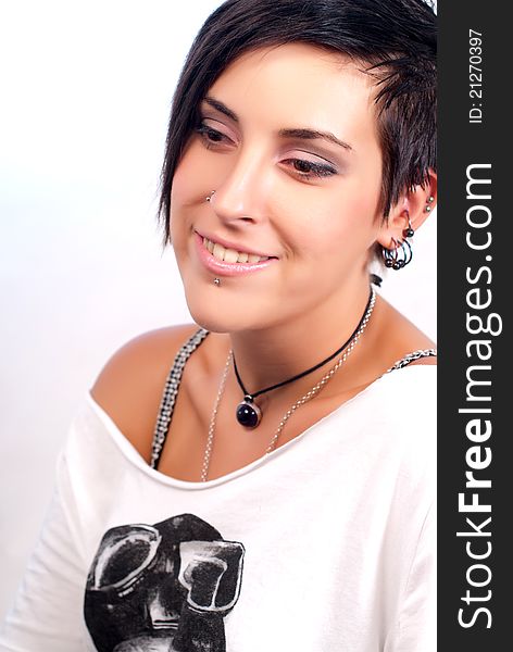 Happy brunette teenager girl with rock attitude on white background. Happy brunette teenager girl with rock attitude on white background