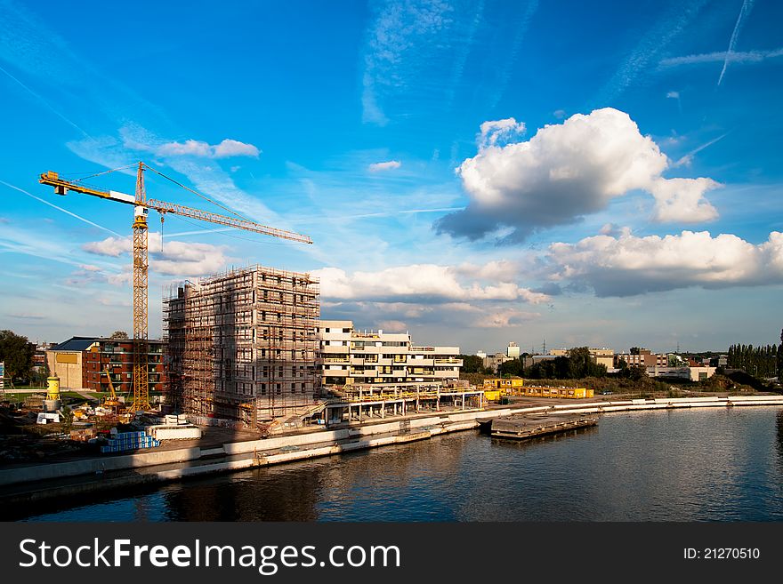 Crane and a building structure on the embankment of the river. Crane and a building structure on the embankment of the river