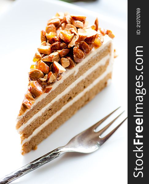 A delicious coffee almond cake on white dish