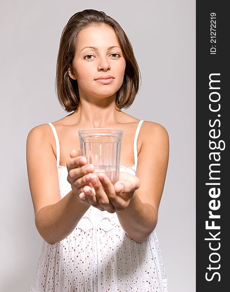 Girl with a glass of water in the studio. Girl with a glass of water in the studio