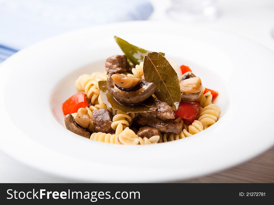 Pasta with beef, pepper and mushrooms; flavored with bay leaves. Pasta with beef, pepper and mushrooms; flavored with bay leaves
