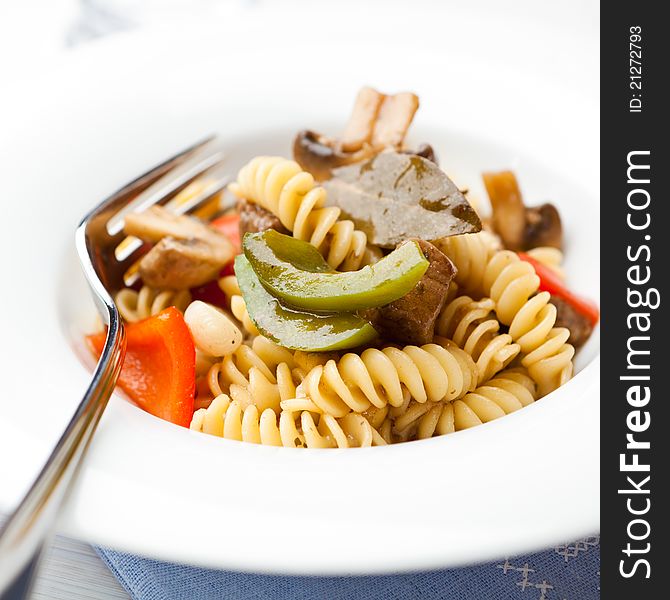 Pasta with beef, pepper and mushrooms; flavored with bay leaves. Pasta with beef, pepper and mushrooms; flavored with bay leaves