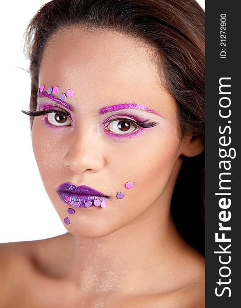 Close up of an Asian female's face wearing pink and purple makeup. Close up of an Asian female's face wearing pink and purple makeup