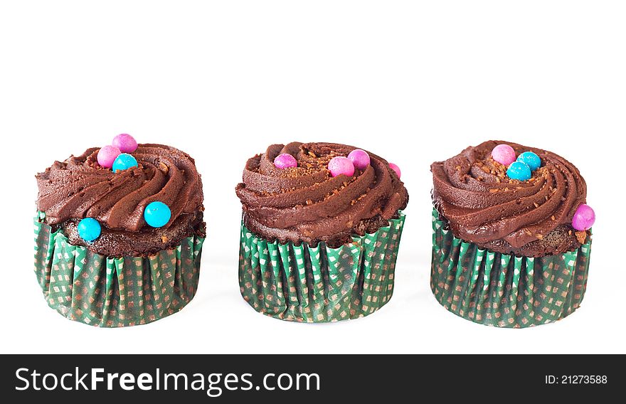 Miniature decorated chocolate cupcakes isolated on white background. Miniature decorated chocolate cupcakes isolated on white background