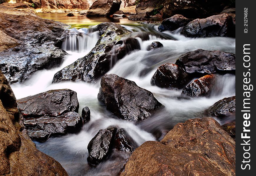 A mountain stream runs wild through rocks. A mountain stream runs wild through rocks