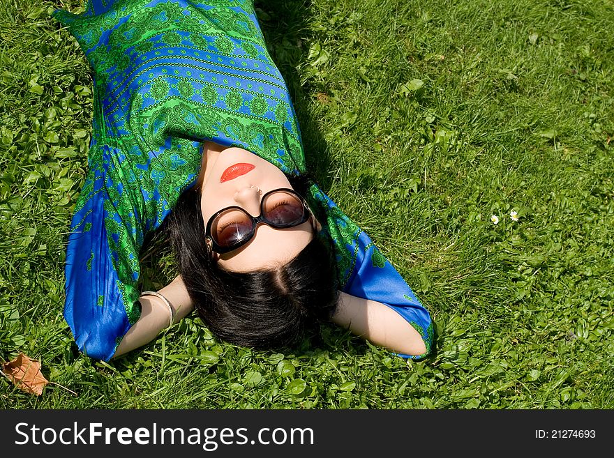 Girl resting on grass in park