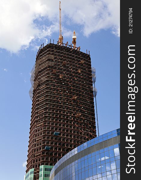 Building a skyscraper on blue sky background. Building a skyscraper on blue sky background.