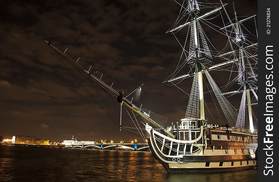 Old ship on the Neva river, against the background of the Palace Bridge, night view