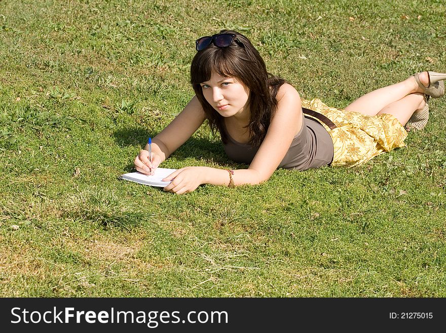 Girl lying on grass in park