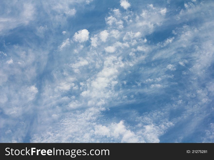 White fluffy clouds on the background of blue sky