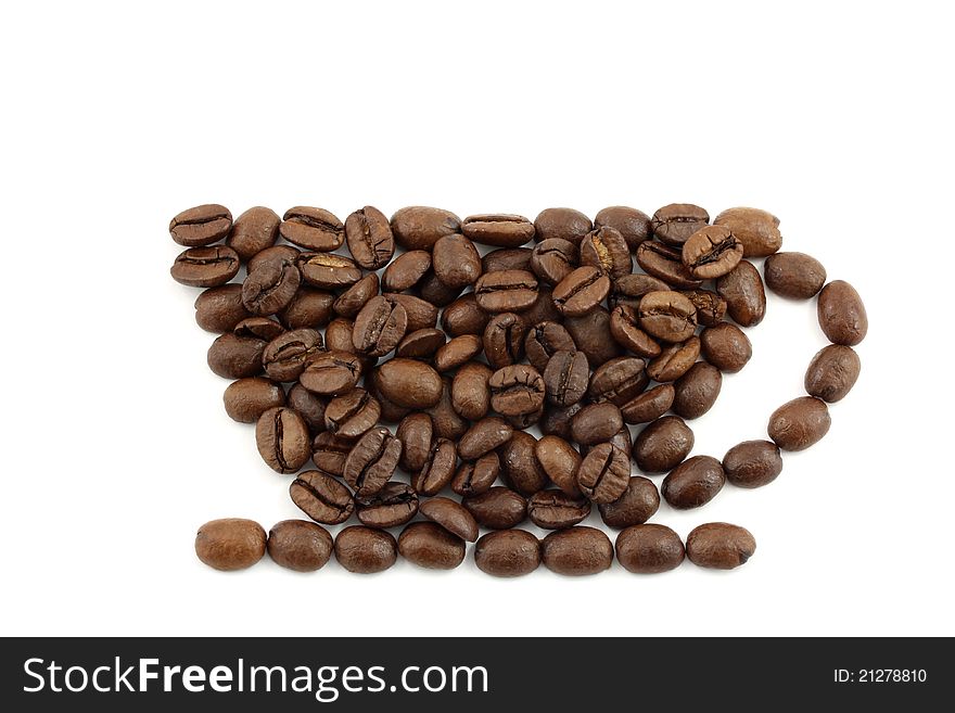 A cup figured by coffee beans on white background. A cup figured by coffee beans on white background