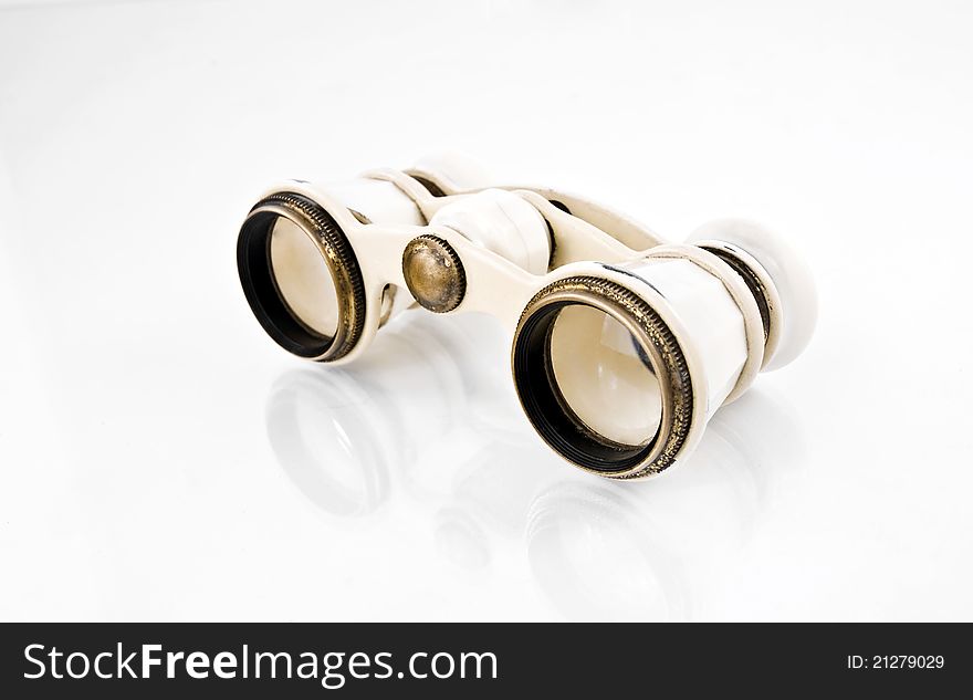 Old opera binoculars on a white