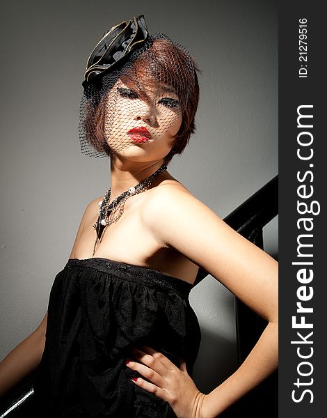 Beautiful young Asian female low key in black dress. Beautiful young Asian female low key in black dress