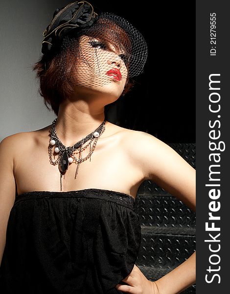 Beautiful young Asian female low key in black dress. Beautiful young Asian female low key in black dress