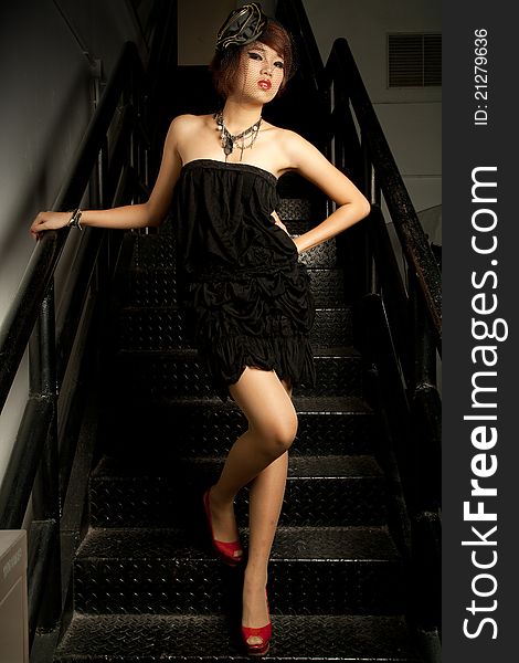 Beautiful young Asian female low key in black dress. Beautiful young Asian female low key in black dress