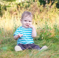 Baby Sitting On Grass Royalty Free Stock Photos