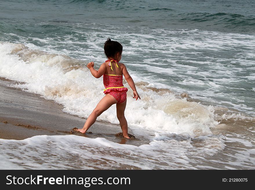 Little girl in pink swimwear near the sea. Little girl in pink swimwear near the sea