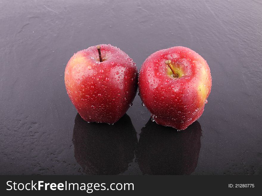 Two red apple on wet floor. Two red apple on wet floor