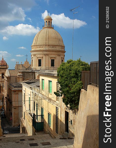The dome of San Nicolo cathedral in Noto viewed from the top of steps in sidelight. The dome of San Nicolo cathedral in Noto viewed from the top of steps in sidelight