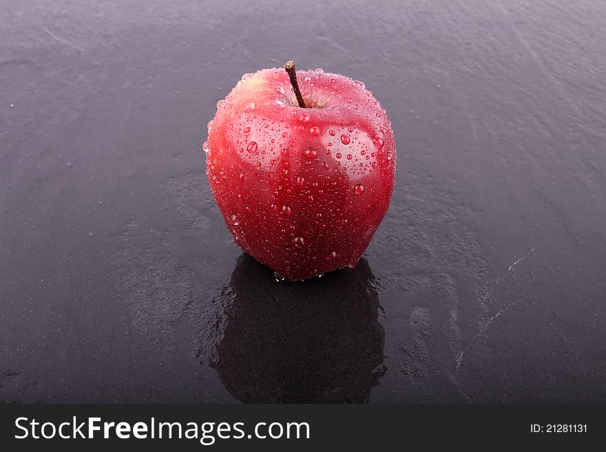 Apple on the wet ceramic floor