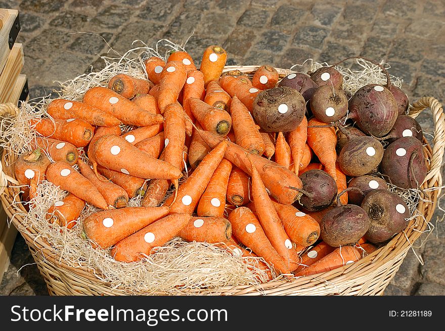 Large basket of carrots and beets in the market. Large basket of carrots and beets in the market