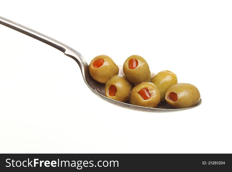 Pimento stuffed olives in a silver spoon isolated against white. Pimento stuffed olives in a silver spoon isolated against white
