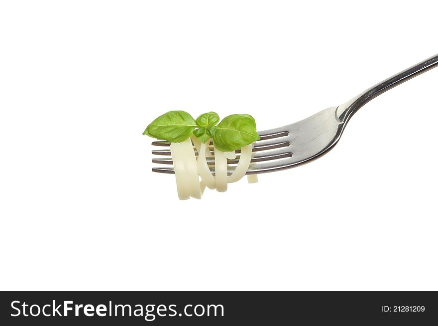 Spaghetti and sprig of basil on a fork isolated against white. Spaghetti and sprig of basil on a fork isolated against white
