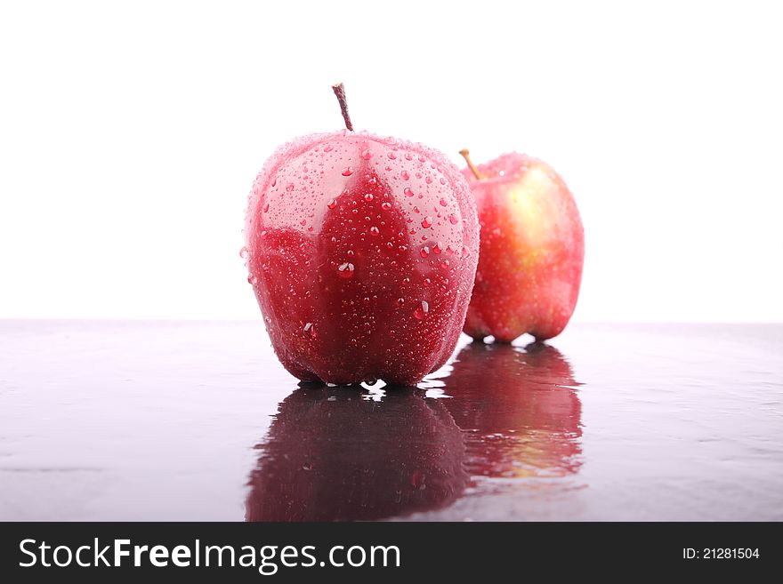 Apple with dropless on wet floor. Apple with dropless on wet floor