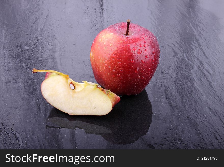 Apple with dropless on wet floor. Apple with dropless on wet floor