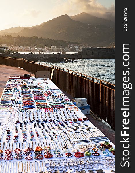 Table with bijouterie on seafront at sunset, Sicily. Table with bijouterie on seafront at sunset, Sicily
