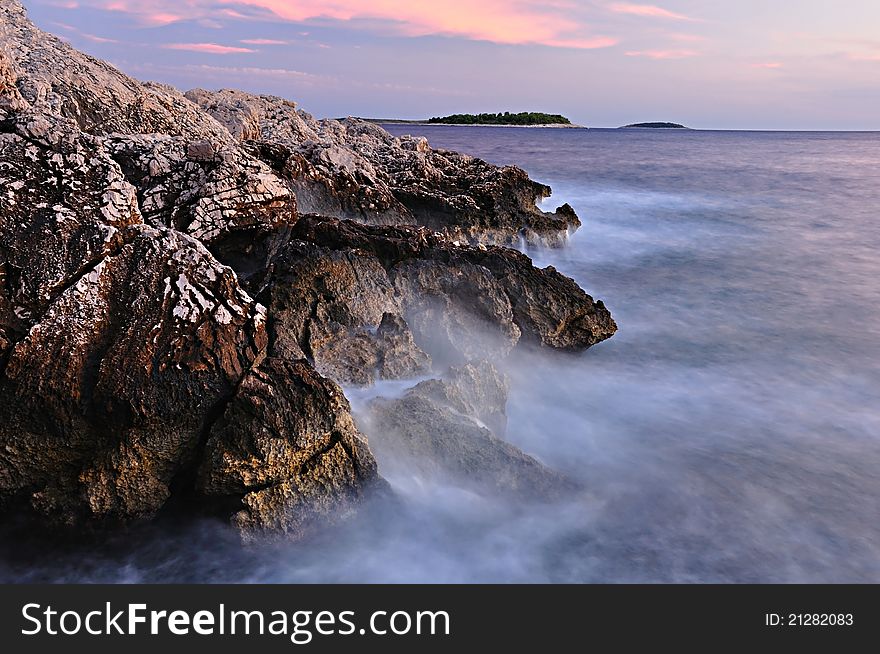 Rocky coast in Croatia during the evening walk along the nearby town Primosten. Rocky coast in Croatia during the evening walk along the nearby town Primosten