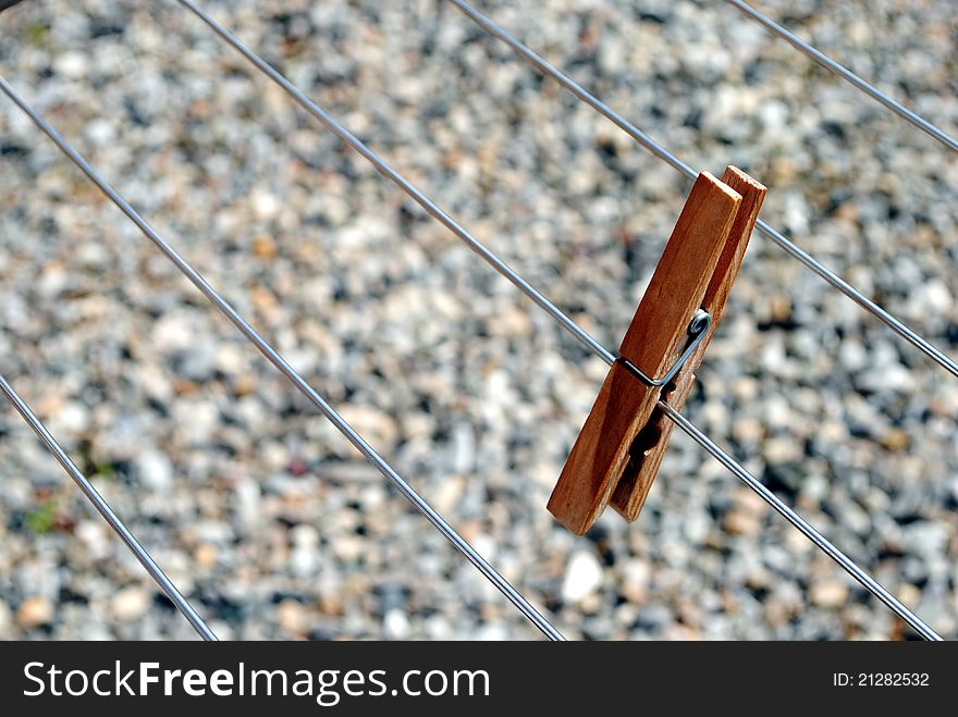 Clothes peg standing on the line, stones background