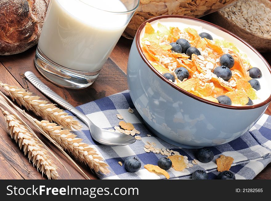 Healthy breakfast with cereals and blueberries on the wooden table