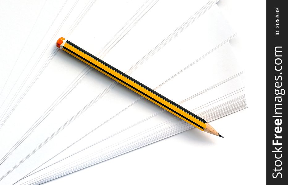 Pencil lying on a clean white paper. Pencil lying on a clean white paper