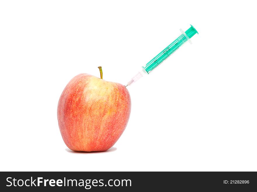 Red apple with a syringe on white background. Red apple with a syringe on white background