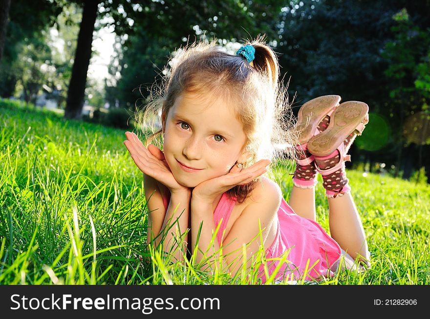 Portrait of little girl on grass