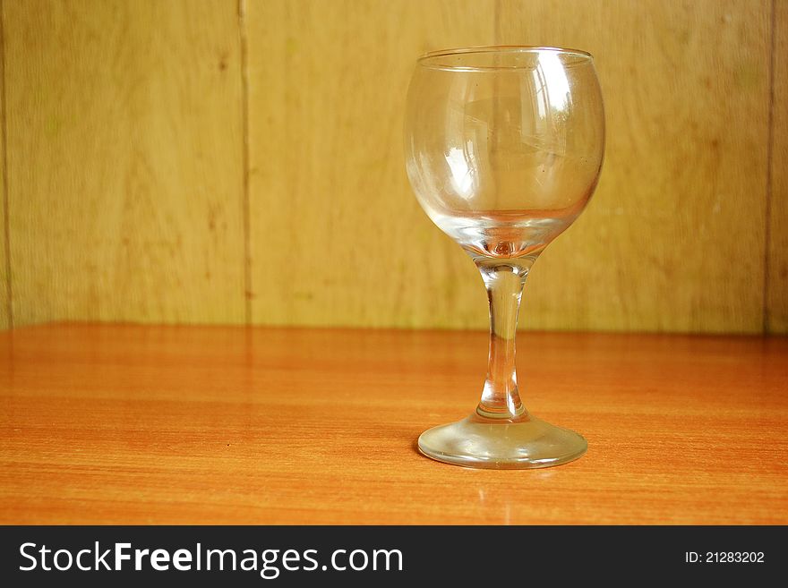 The photo of wine glass on the wooden table