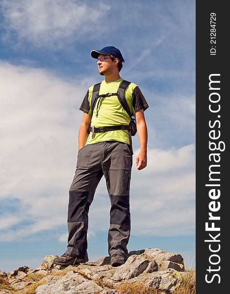 Young tourist on the top of mountain massif.