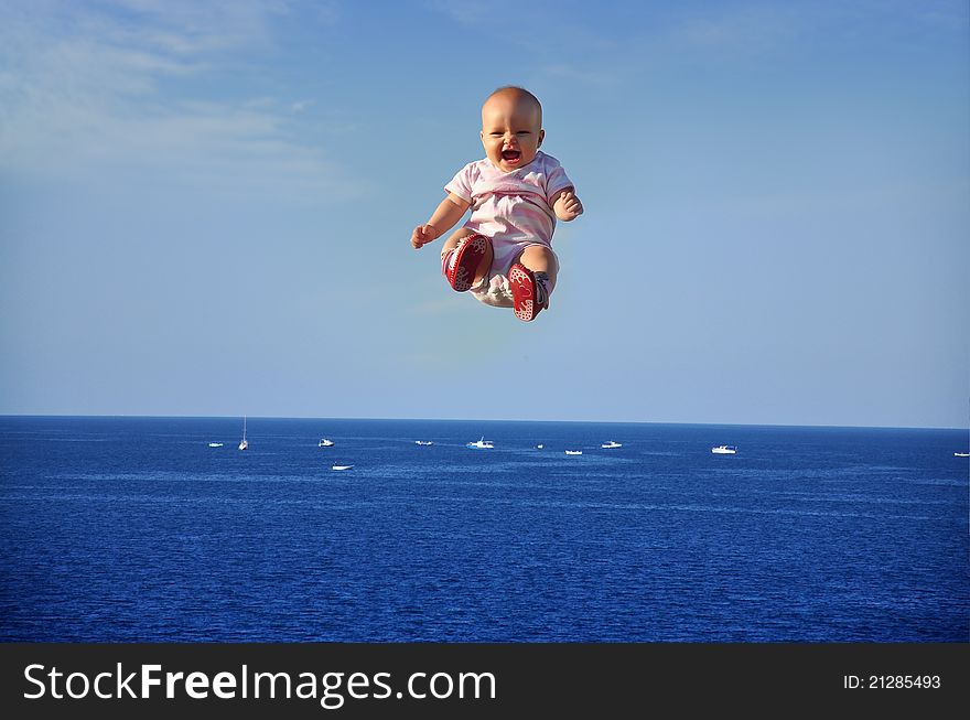 Child embodied in flight against a background of sea and clear sky. Child embodied in flight against a background of sea and clear sky