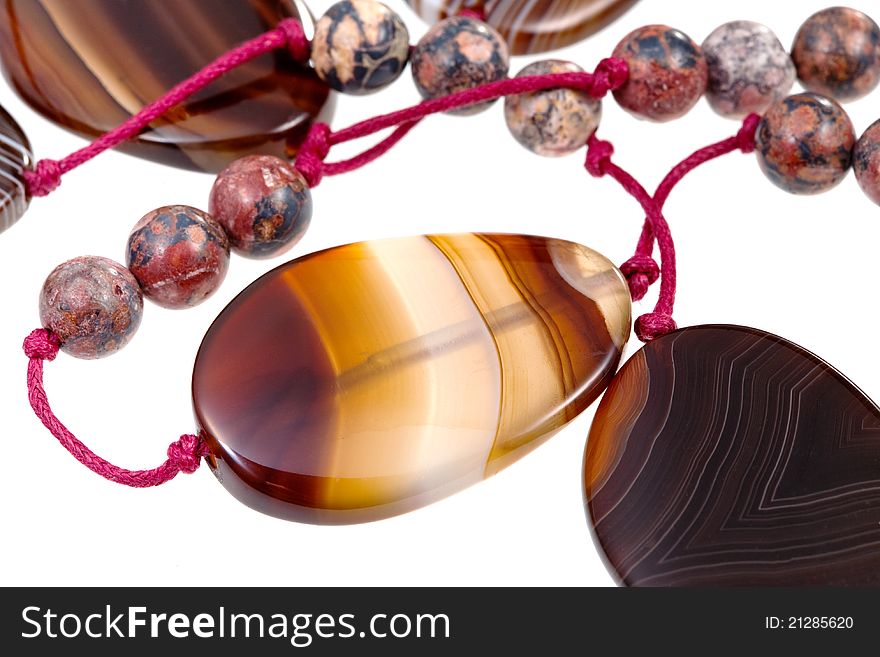 Fragment agate lady's bead closeup isolated on white