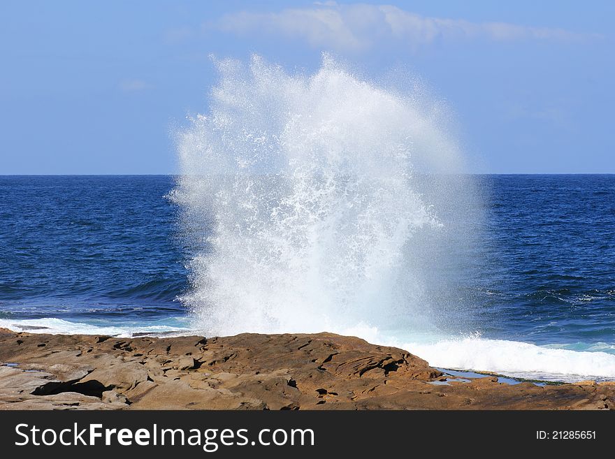 Ocean wave fountain at rock