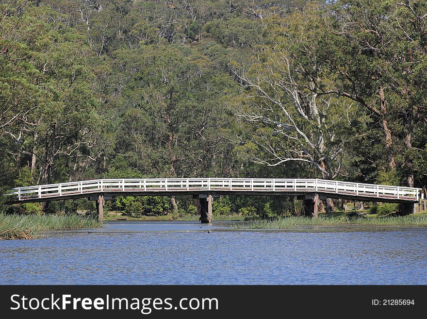 An old bridge crossing the Hacking River in the Royal National Park - a characteristic Australian landscape. An old bridge crossing the Hacking River in the Royal National Park - a characteristic Australian landscape