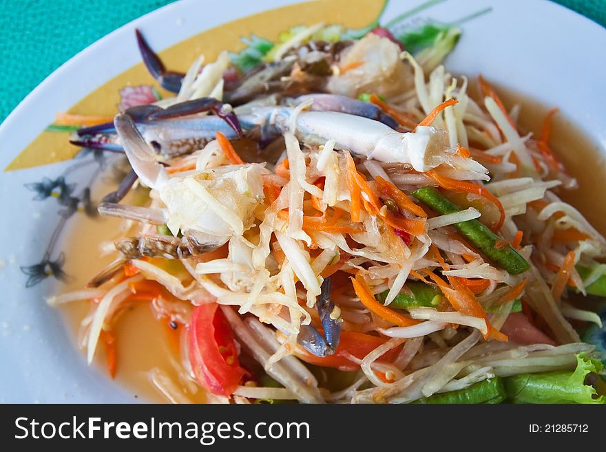 Thai papaya salad with horse crab on table. Thai papaya salad with horse crab on table.