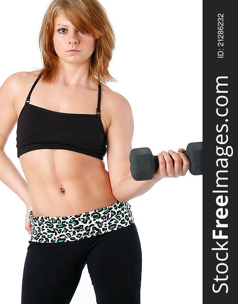 Young woman poses curling a dumbbell wearing sports bra with leggings. Young woman poses curling a dumbbell wearing sports bra with leggings.