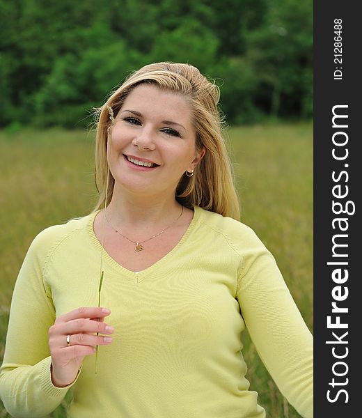 Beautiful natural woman with pure healthy skin outdoors on spring field. Switzerland. Beautiful natural woman with pure healthy skin outdoors on spring field. Switzerland